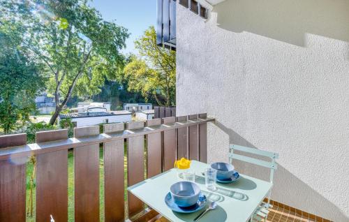 a white table with dishes on it on a balcony at Pet Friendly Apartment in Saint-Georges-de-Didonne
