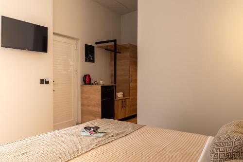 a bedroom with a bed with a pair of sunglasses on it at Bali Seaside Sailor in Balíon
