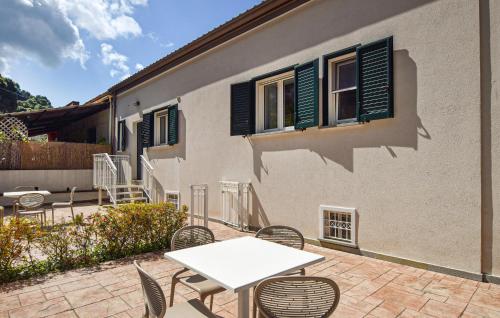 a patio with a table and chairs and a building at 1 Bedroom Gorgeous Home In Castellabate in Castellabate