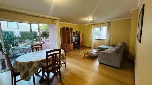 a living room with a table and a couch at Apto Barreiro by Susy's Holidays in Funchal