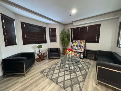 a living room with two couches and a table at SureStay by Best Western Salt Lake City Downtown in Salt Lake City
