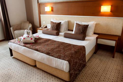 a hotel room with a bed with two stuffed animals on it at Blanca Hotel in Izmir