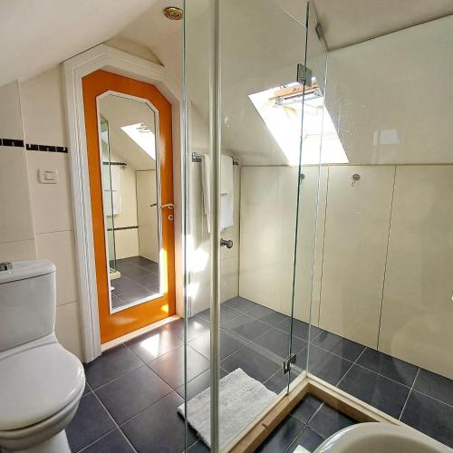 a bathroom with a toilet and a glass shower at Boutique Guest Accommodation Zephyrus in Split