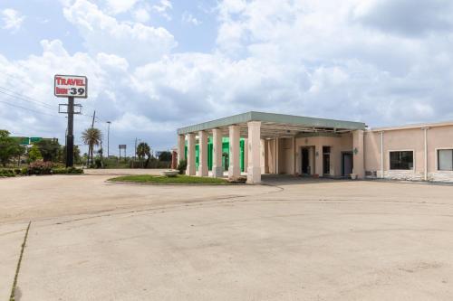 an empty parking lot in front of a mobil gas station at Travel Inn & Suites in Humble