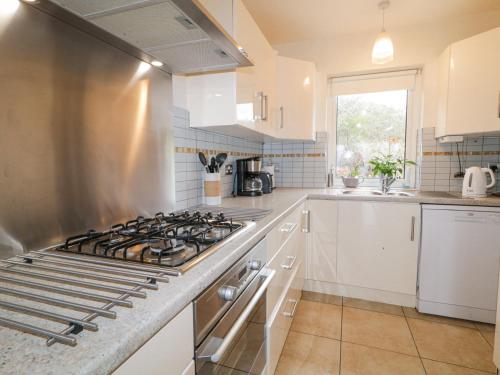 a kitchen with a stove top oven in a kitchen at Loistin Coimin in Ballybofey