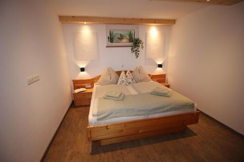 a bedroom with a large bed with two lamps at Zur STOCKERin - Ferienwohnung in Schladming