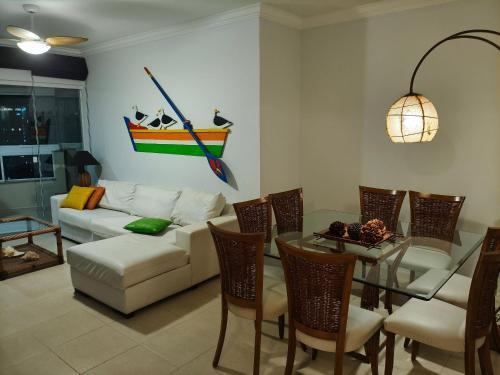 un soggiorno con un divano e un tavolo di vetro di Encanto nas Alturas: Acomode-se no Elegante Edifício Arnoldo Werner em Balneário Camboriú a Balneário Camboriú