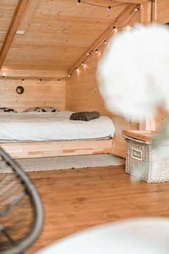 a room with a bed in a wooden cabin at Mr.Banga in Alūksne