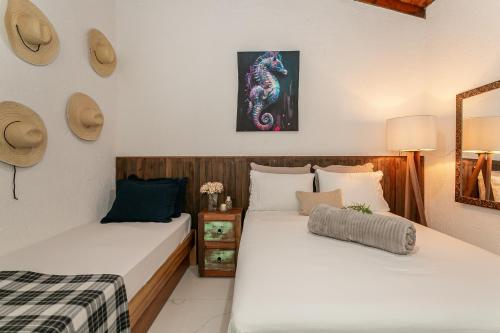 two beds sitting next to each other in a room at RJ Residencial Beira Mar in Palhoça