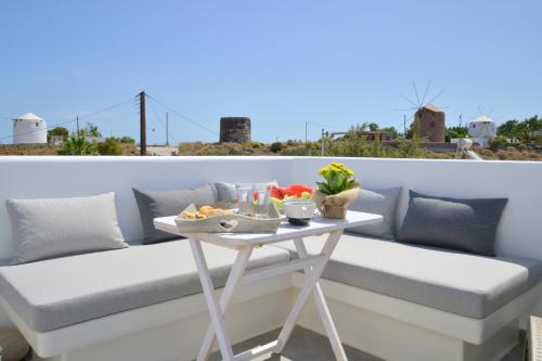 a table with a tray of food on a balcony at Chaido Studios in Plaka Milou
