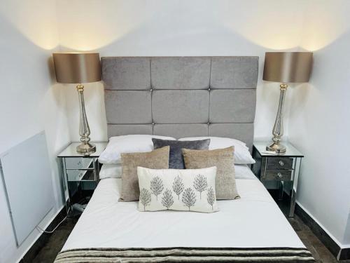 a bedroom with a white bed with two lamps at Casa Dolly Boutique B&B in Cantoria