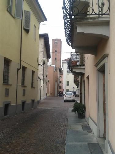 an alley with a car parked on a street at La trifula bianca apts. in Alba