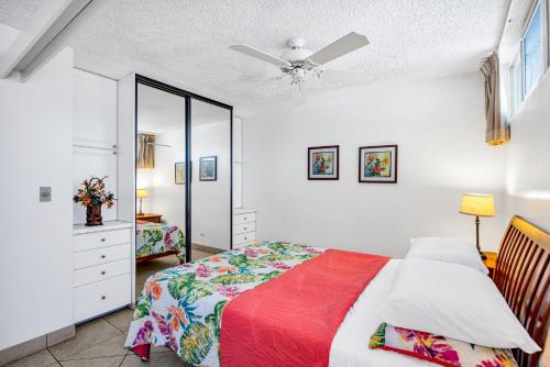 a bedroom with a bed and a ceiling fan at Hale Kai O'Kihei 118 in Kihei