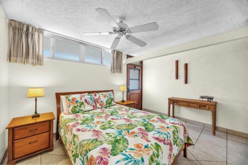 a bedroom with a bed and a ceiling fan at Hale Kai O'Kihei 118 in Kihei