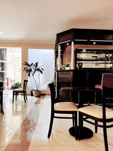 a living room with chairs and a piano at Hotel Aire de Patagonia in Río Gallegos
