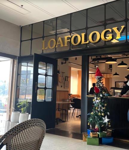 a restaurant with a christmas tree in front of it at Gold Crest Mall Luxury Apartments by NestNow in DHA Phase 4 Lahore in Lahore
