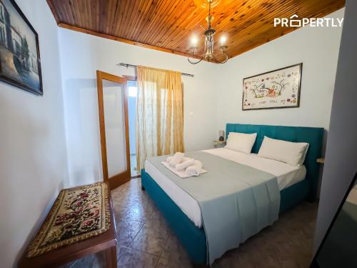 a bedroom with a white bed with a blue headboard at Cypress Seaside Apartment #PROPERTLY in Nea Kallikrateia