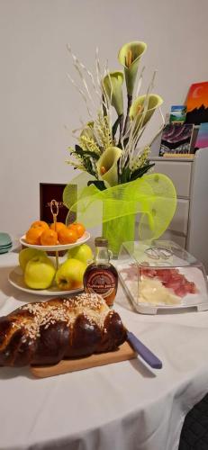 a table with a plate of food on a table at Le Farfalle di Armeno in Armeno