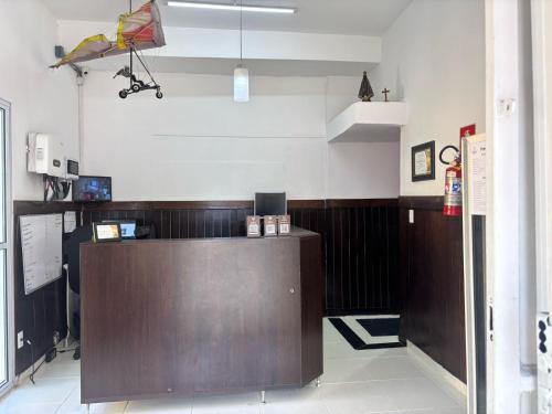 a restaurant with a counter in a room at Pousada São Luiz in Bragança Paulista