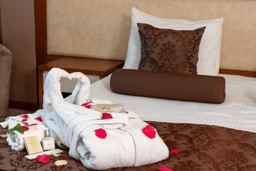 a hotel room with a pile of towels on a bed at Blanca Hotel in Izmir