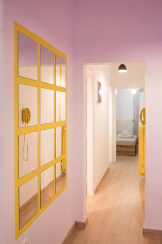 a room with a window and a hallway at The Yellow Dot in Thessaloniki