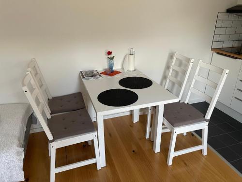 a white table and chairs in a room at Country Lodge Lärkboet in Laholm