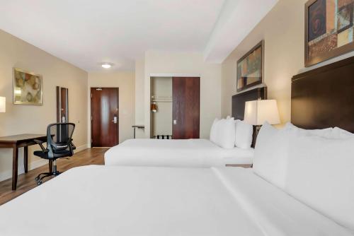 a hotel room with two beds and a desk at Comfort Hotel Bayer's Lake in Halifax