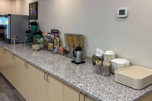 a kitchen with a counter top with some items on it at Quality Inn & Conference Centre Downtown Sudbury in Sudbury