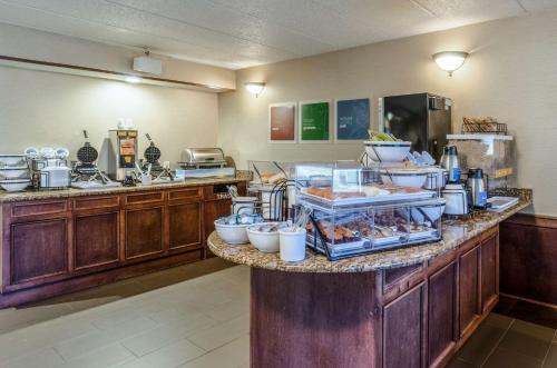 a kitchen with a buffet of food on a counter at Comfort Inn & Suites West Springfield in West Springfield