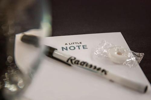a tube of toothbrush sitting on top of a table at Radisson Hotel Southfield-Detroit in Southfield