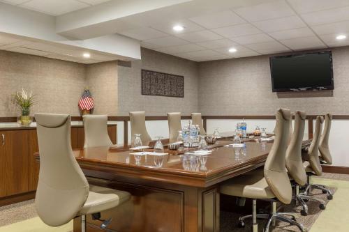a conference room with a large wooden table and chairs at Radisson Hotel Southfield-Detroit in Southfield