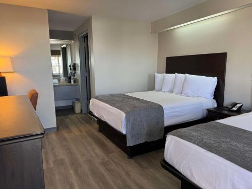 a hotel room with two beds and a bathroom at SureStay by Best Western Salt Lake City Downtown in Salt Lake City