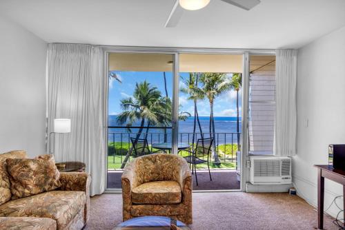a living room with a couch and a chair at Hale Kai O'Kihei 301 in Kihei