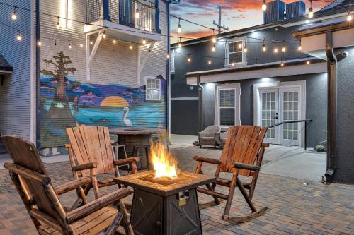 two chairs and a fire pit in front of a house at Spectacular Suites Sleep 20 Near Fq W Pool in New Orleans