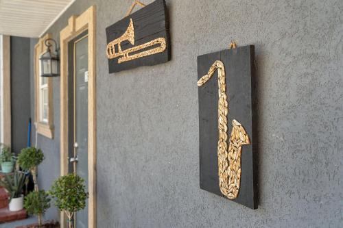 a sign on the side of a building with a saxophone at Spectacular Suites Sleep 20 Near Fq W Pool in New Orleans