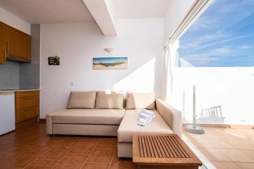 a living room with a couch and a table at NEW !! Studio Ria Formosa - Cabanas de Tavira in Cabanas de Tavira