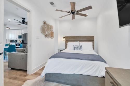 a bedroom with a bed and a ceiling fan at Spectacular Suites Sleep 20 Near Fq W Pool in New Orleans
