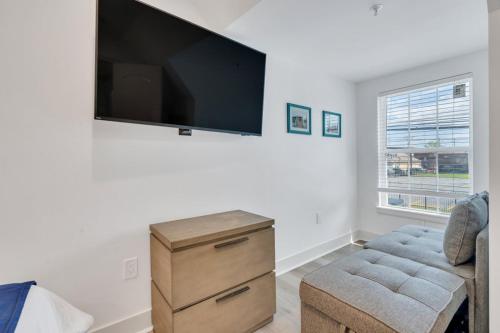 a living room with a large flat screen tv on the wall at Spectacular Suites Sleep 20 Near Fq W Pool in New Orleans