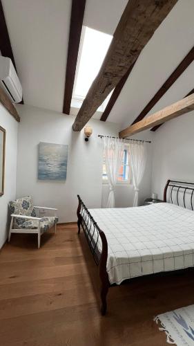 a bedroom with a large bed and a window at Vila More moje A2 in Vis