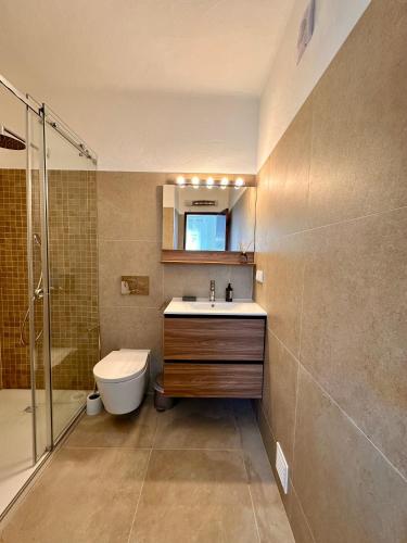 a bathroom with a sink and a shower and a toilet at Casino 5 in Carvoeiro
