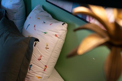 a white pillow with sprinkles on it sitting on a bed at Le CAILLOU in La Trinité