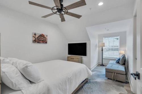 a white bedroom with a bed and a ceiling fan at Spectacular Suites Sleep 20 Near Fq W Pool in New Orleans