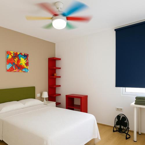 a bedroom with a white bed and a ceiling fan at Avenida del Mar 14 Junio in Castellón de la Plana