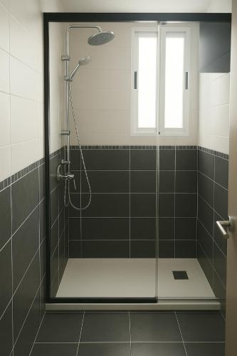 a shower with a glass door in a bathroom at Avenida del Mar 14 Junio in Castellón de la Plana