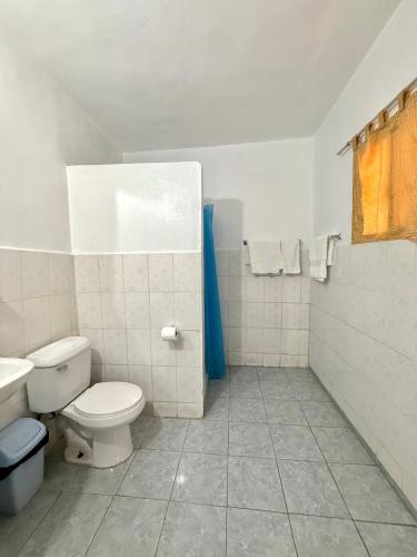 a bathroom with a toilet and a sink at Hotel Al Mare in Santa Cruz de Barahona