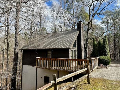 a small house with a porch and a garage at Mystical Haven Honeymoon Cabin in Sevierville