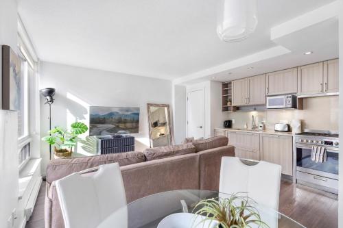 a living room with a couch and a table at Modern, central Vancouver suite in Vancouver