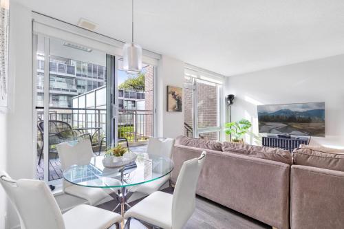 a living room with a couch and a glass table at Modern, central Vancouver suite in Vancouver