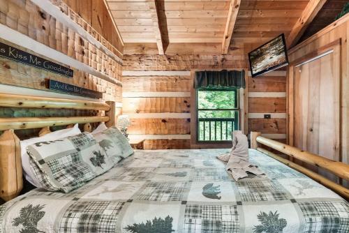 a bedroom with a bed in a log cabin at Blissful Bear Heaven- Honeymoon Cabin in Sevierville