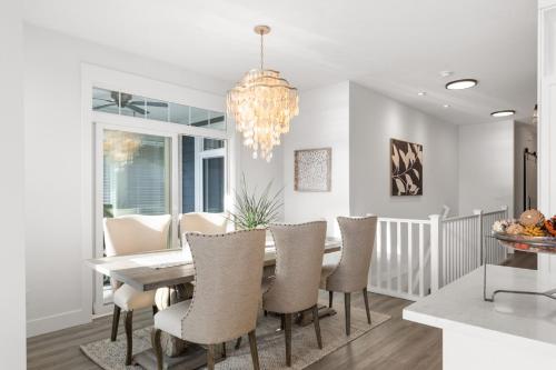 a dining room with a table and chairs and a chandelier at 165 - 2450 Radio Tower Rd-Jacobson in Osoyoos